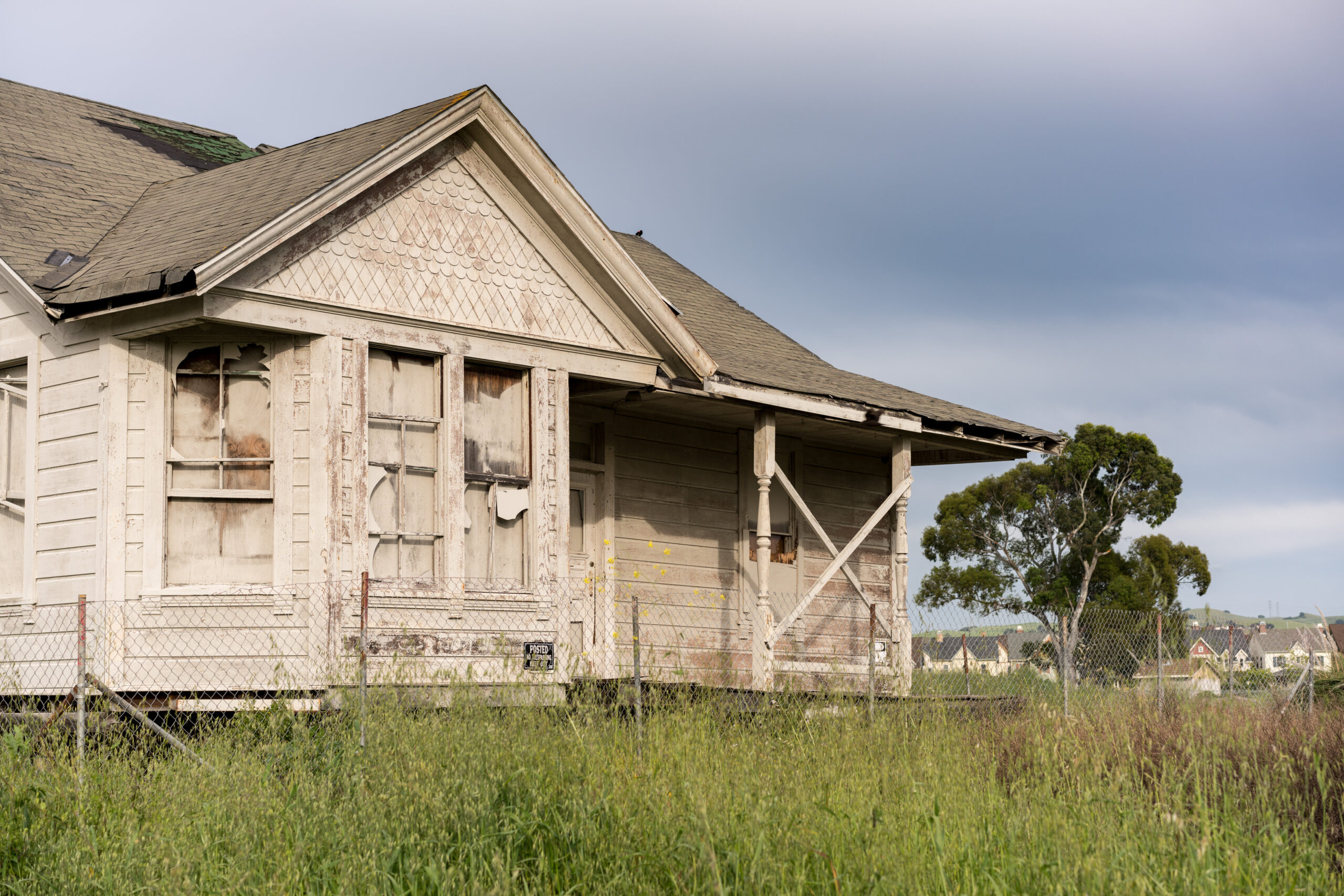 Buying a Fixer Upper - Old worn home exterior in field